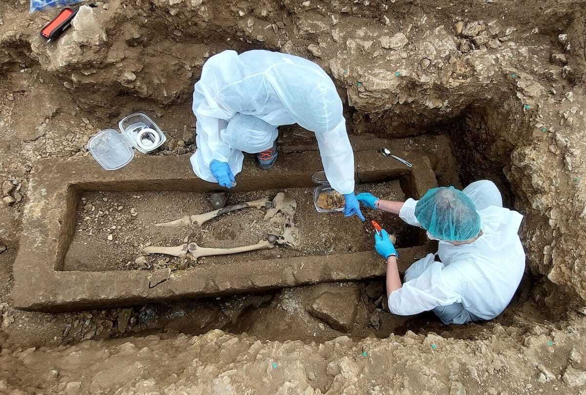 The Iron Age stone sarcophagus, already opened and with the skeleton perfectly preserved inside.